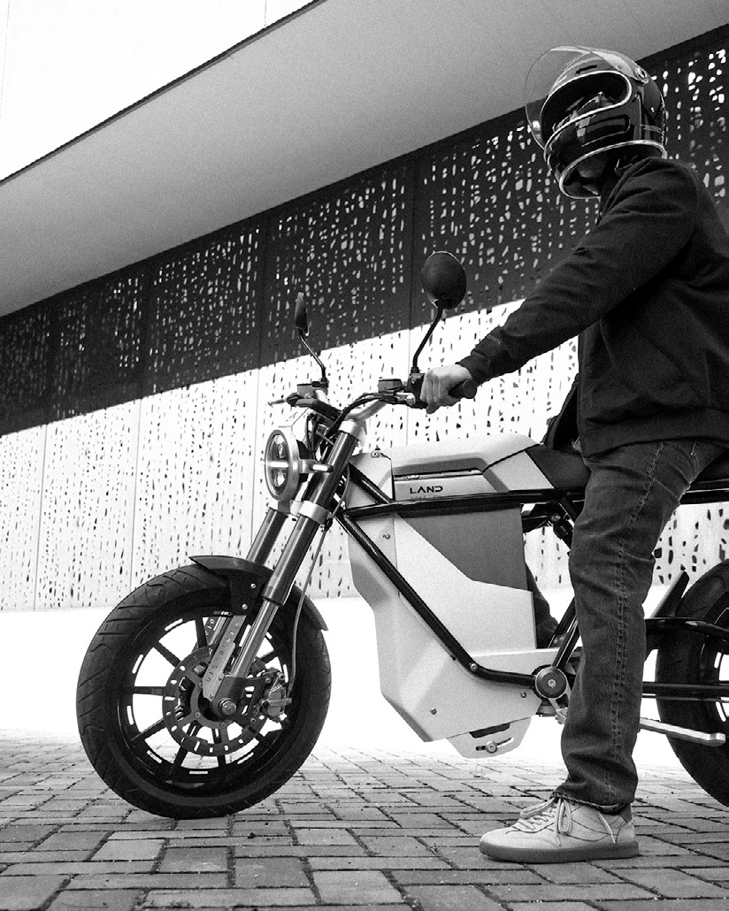 Electric motorcycle prototype lit in low-key studio lighting — vehicle design & development at LAND Labs